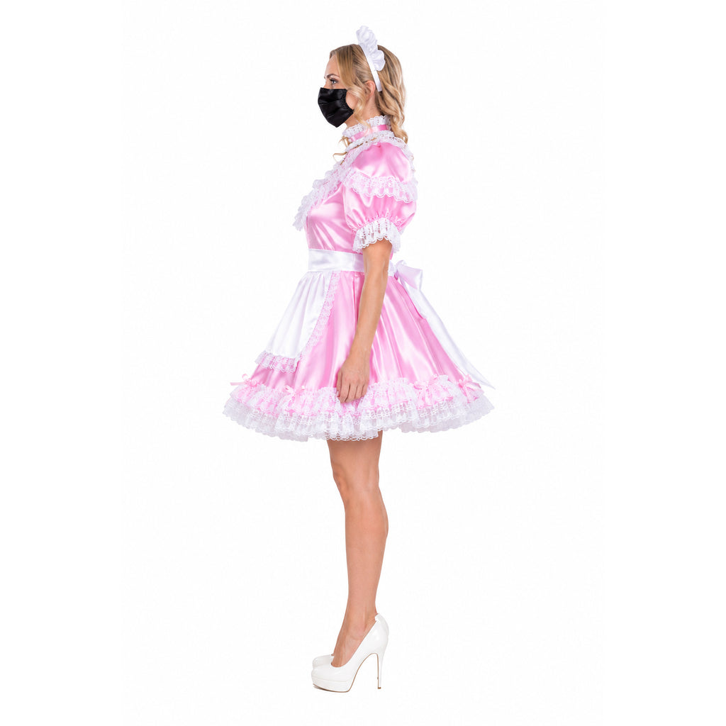 Pink sissy maid dress with white lace, apron, and bow, paired with white heels and headband