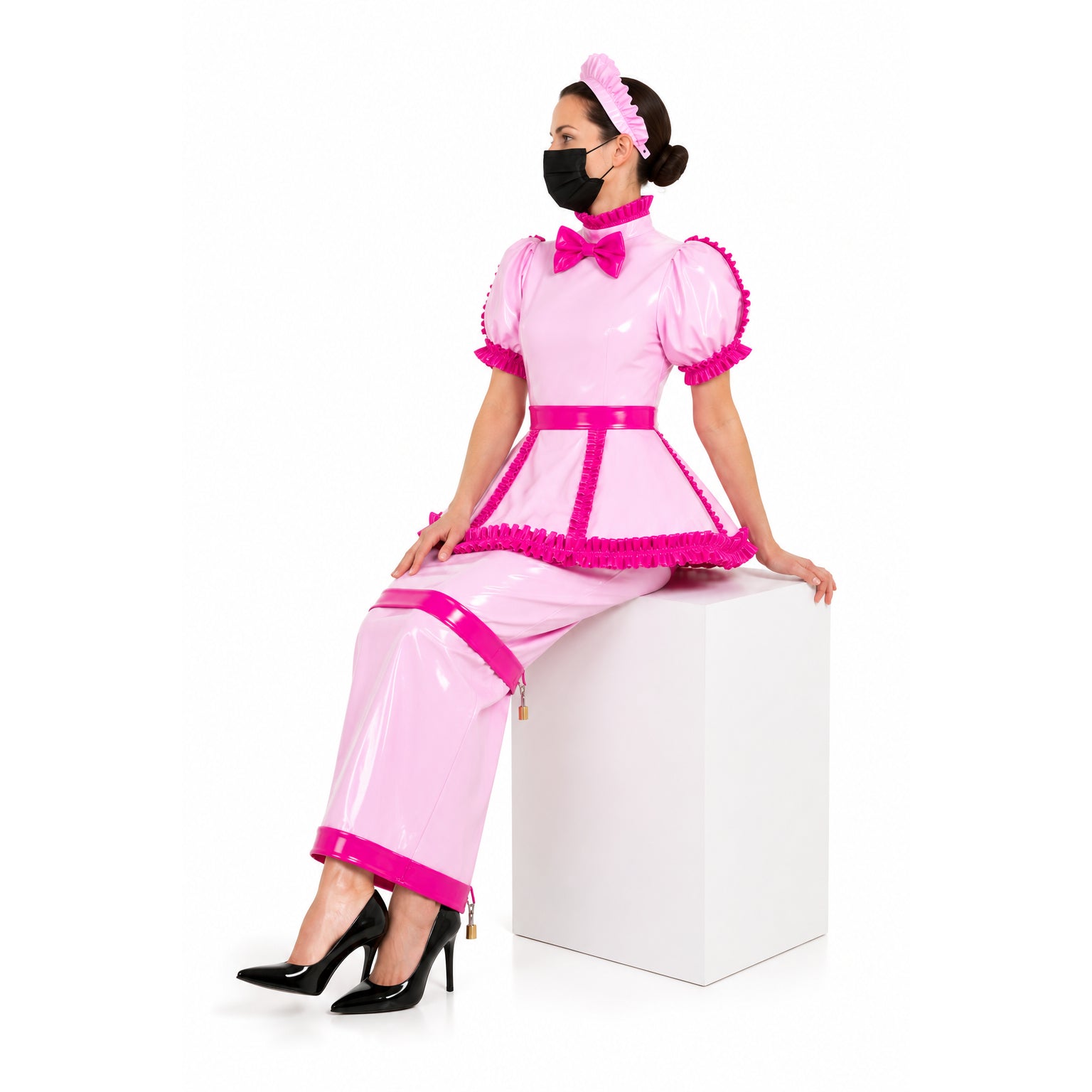 Pink sissy maid dress with ruffles, bow, and lockable design, paired with black heels