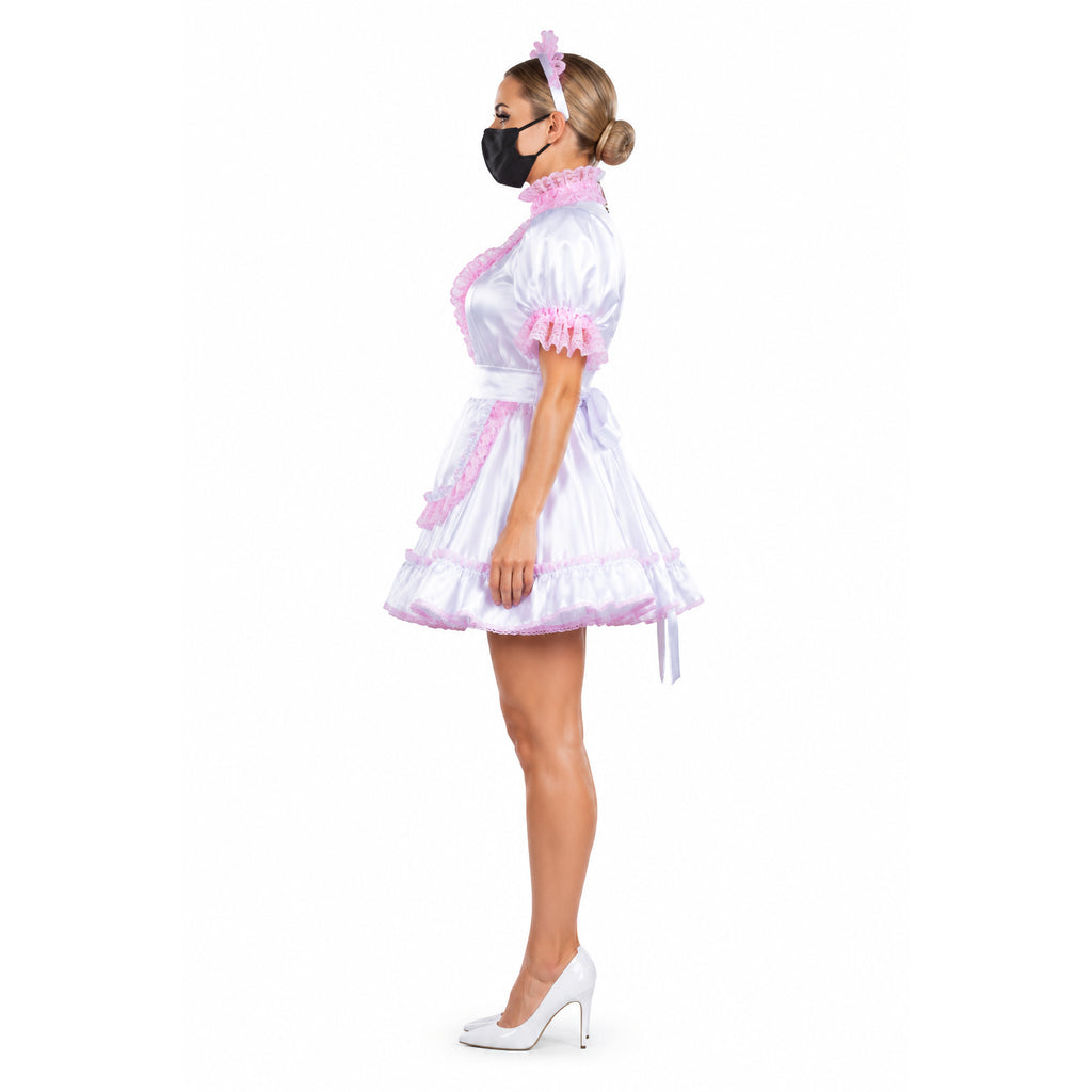 White sissy maid dress with pink lace trim, satin finish, and matching headband, styled with white heels.