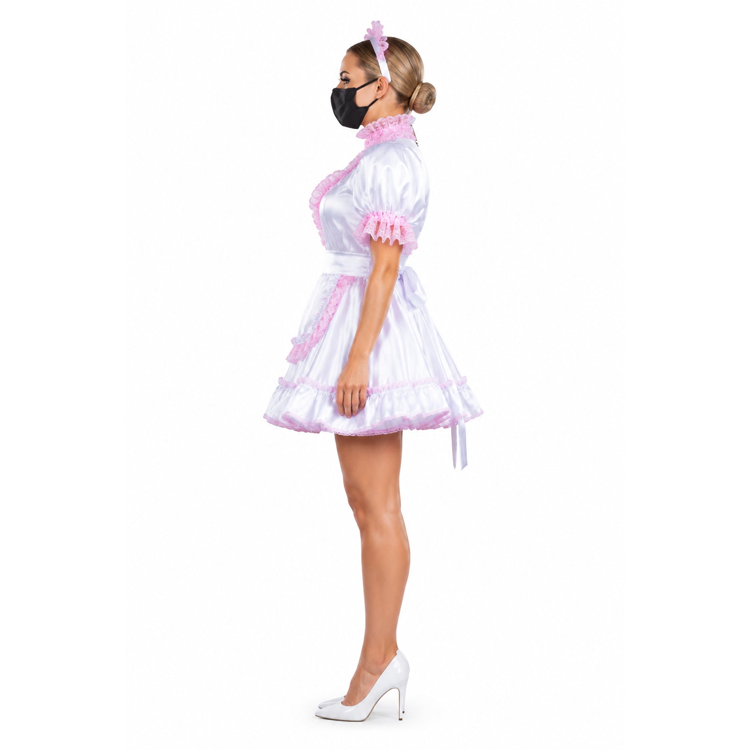 White sissy maid dress with pink lace trim, satin finish, and matching headband, styled with white heels.