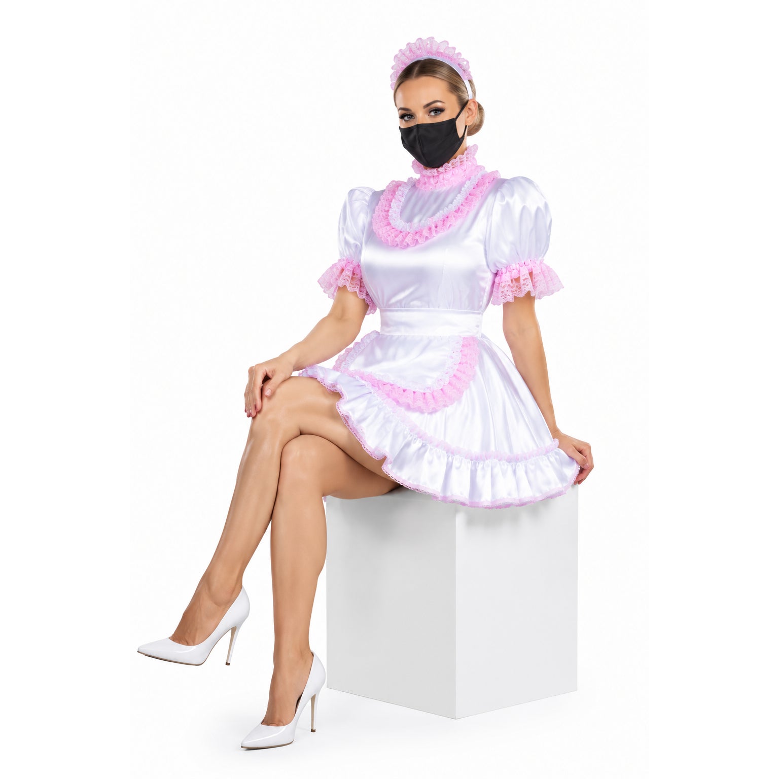 White sissy maid dress with pink lace trim, ruffled collar, and matching headband, styled with white heels.