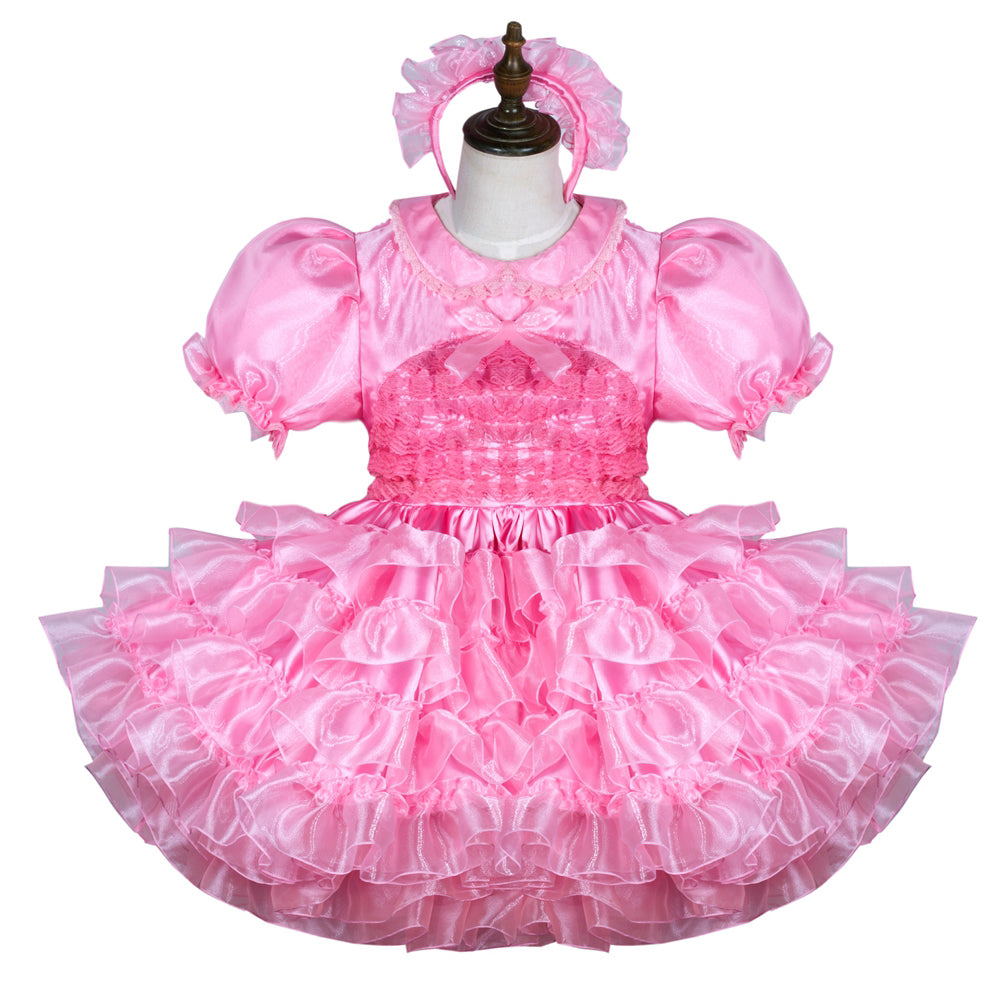 Pink sissy maid dress with ruffles, puffed sleeves, and matching headband on mannequin