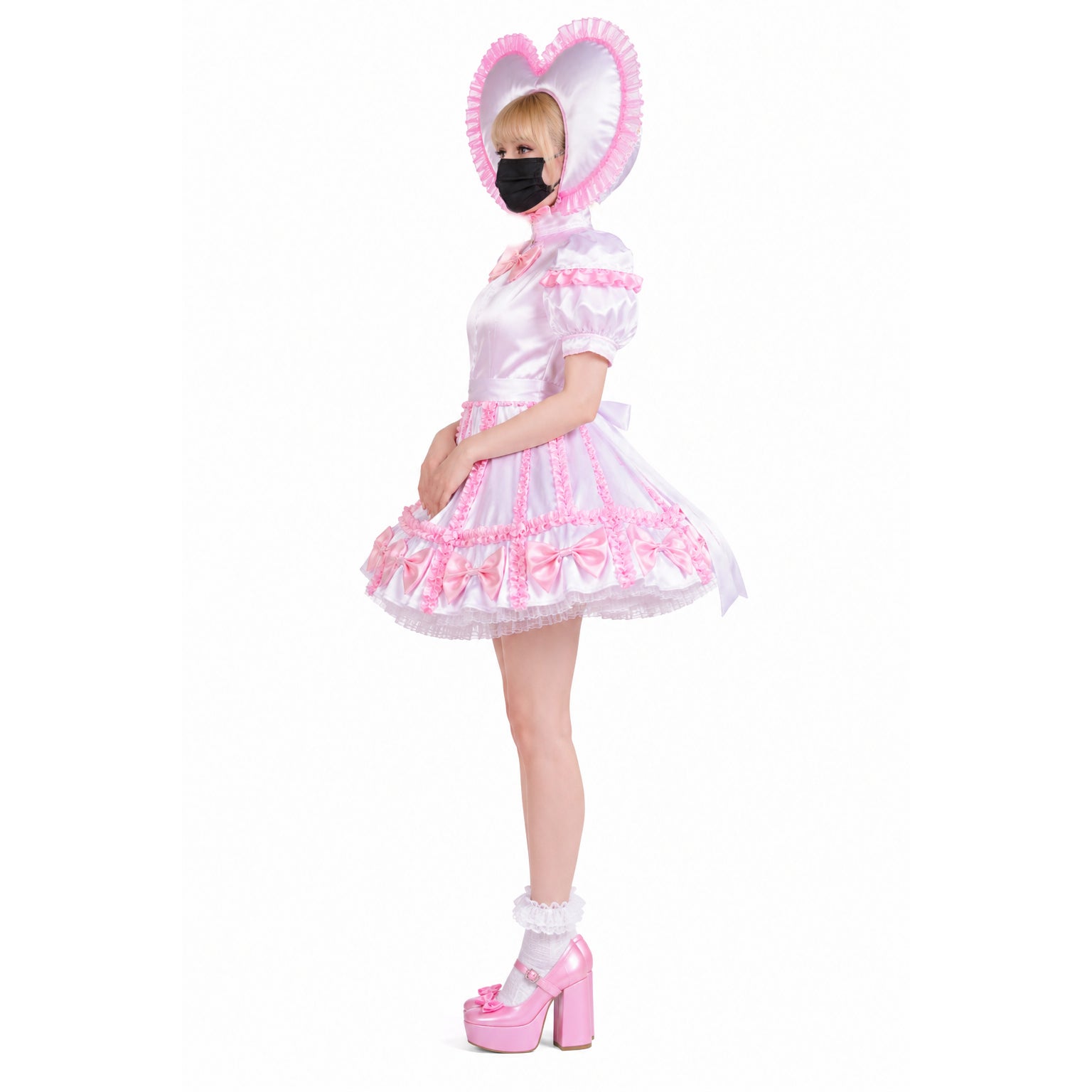 Pink sissy maid dress with heart bonnet, ruffles, and bows, paired with platform heels