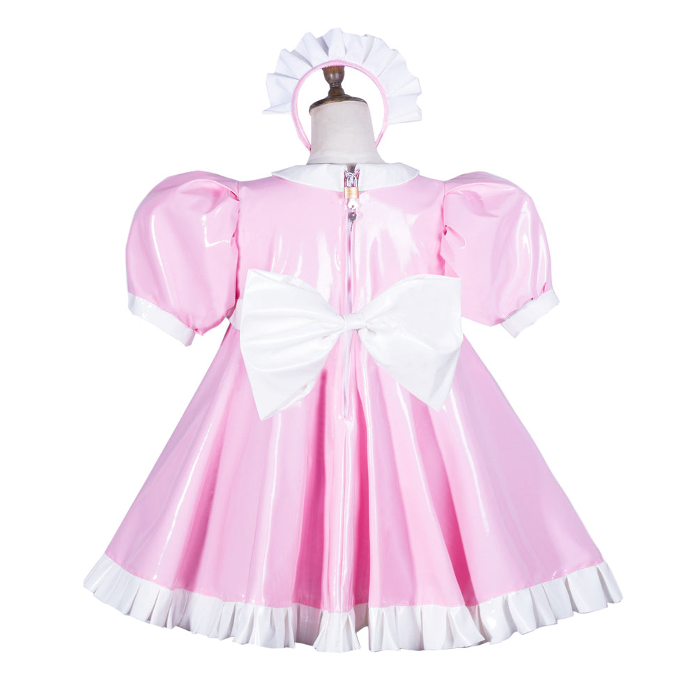 Pink sissy maid dress with white bow, ruffles, and matching headpiece on mannequin