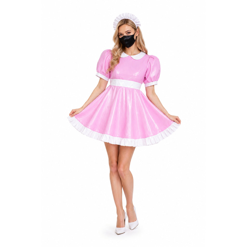 Pink PVC sissy maid dress with white trim, puffed sleeves, and matching hat, styled with heels and mask