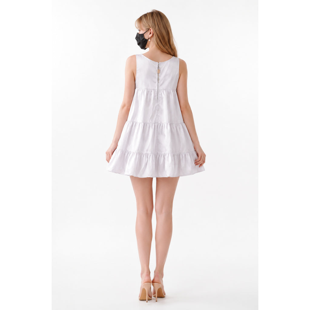 White sissy maid dress with tiered ruffles and back zipper, worn with heels