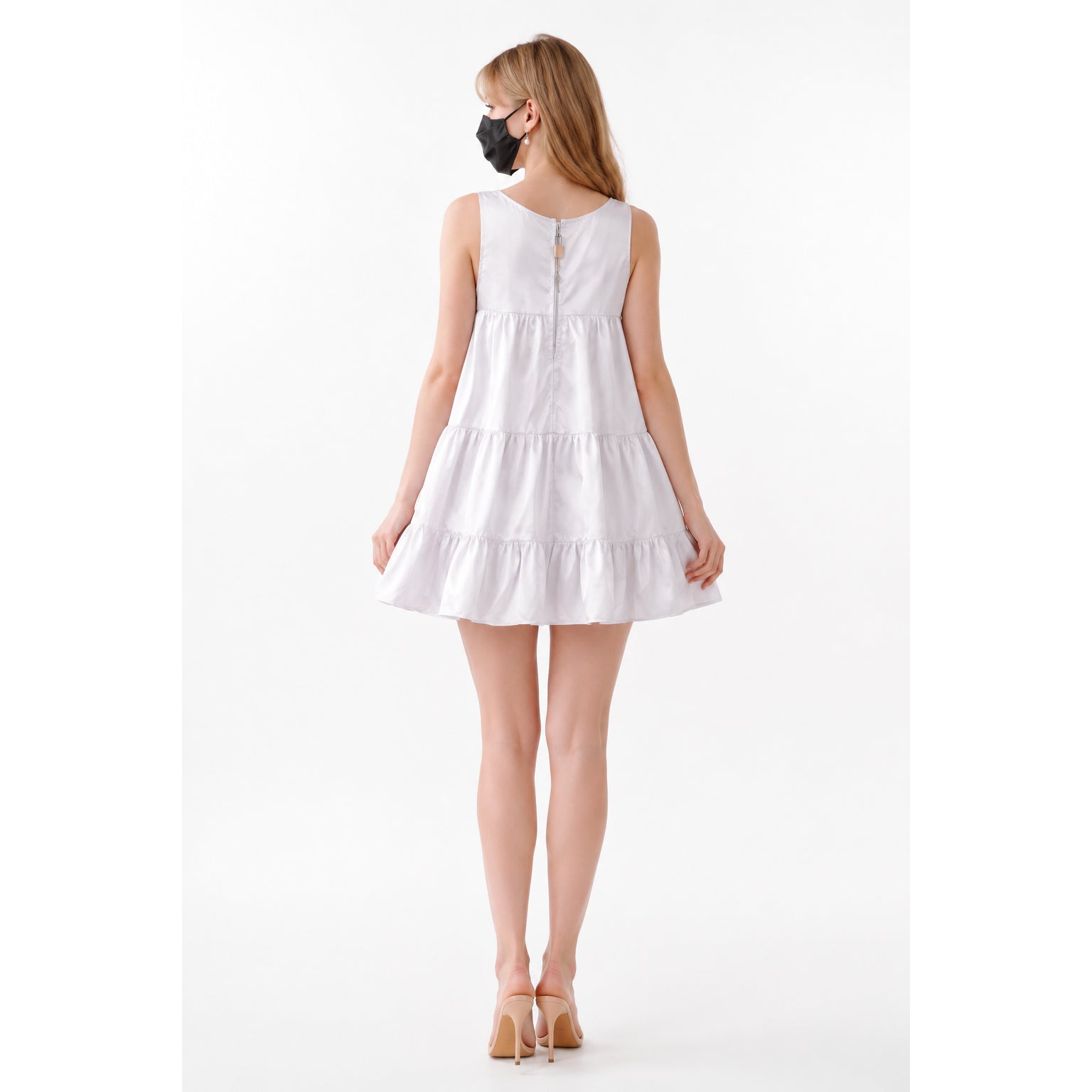 White sissy maid dress with tiered ruffles and back zipper, worn with heels