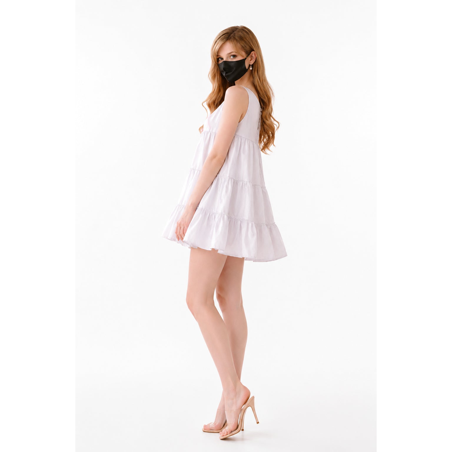 White tiered sissy maid dress with ruffles, worn with black mask and heels