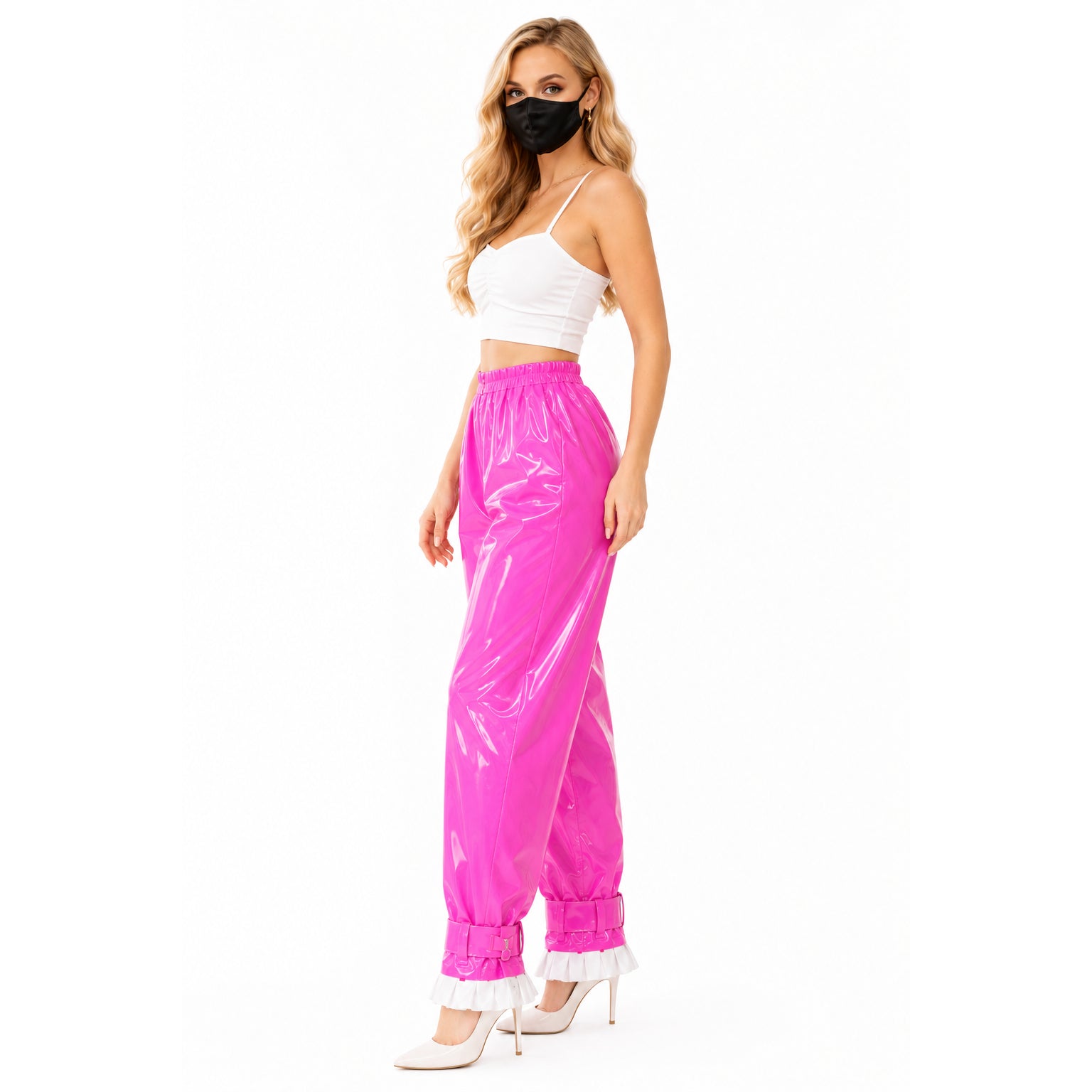 Pink PVC sissy maid pants with ruffles, paired with white crop top and heels