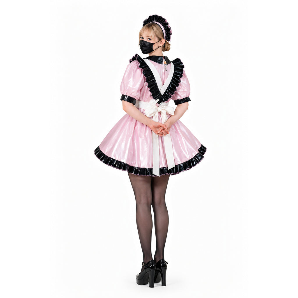 Pink sissy maid dress with black ruffles, white apron, and matching bonnet, styled with heels and stockings.