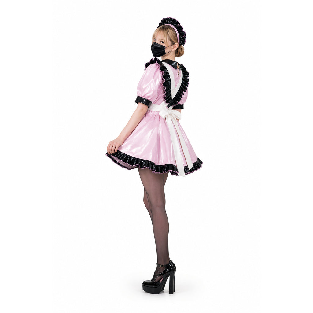 Pink sissy maid dress with black ruffles, white apron, and PVC details, styled with heels and mask