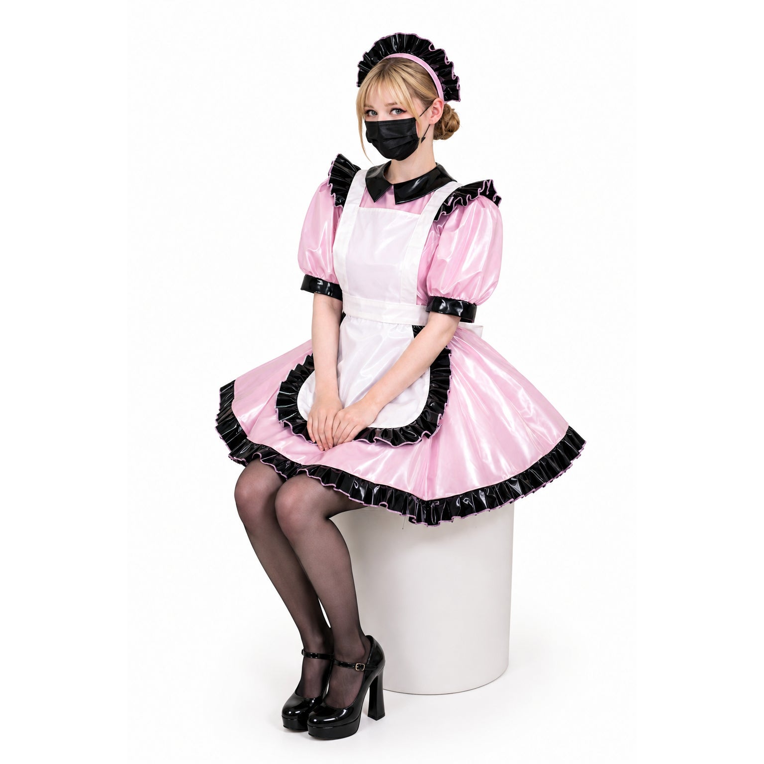 Pink sissy maid dress with black ruffles, PVC apron, and matching headband, styled with heels and stockings