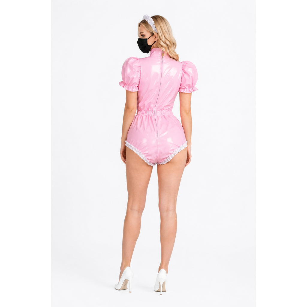 Pink PVC sissy maid dress with puffed sleeves, white ruffles, and back zipper, paired with white heels