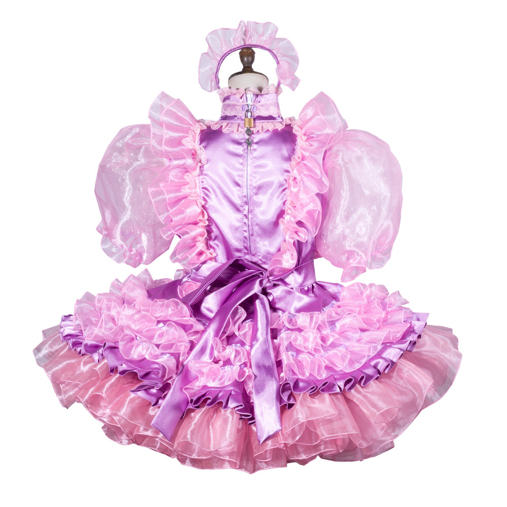 Pink sissy maid dress with ruffles, satin bow, and matching headband on mannequin