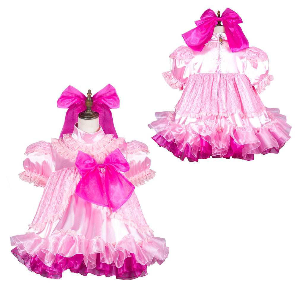 Pink sissy maid dress with ruffles, lace, and bow accents on mannequin