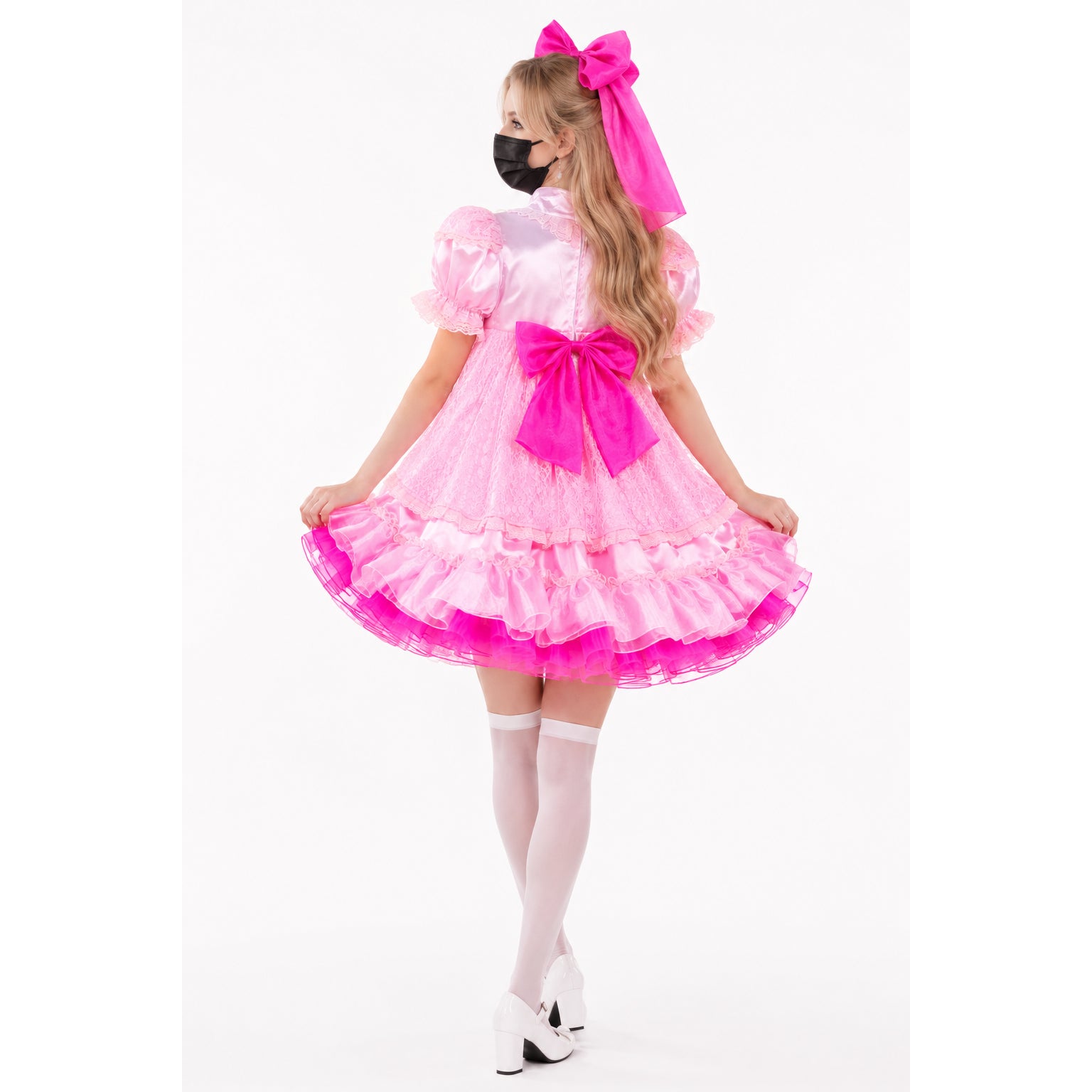 Pink sissy maid dress with lace, ruffles, and bow, paired with white stockings and heels
