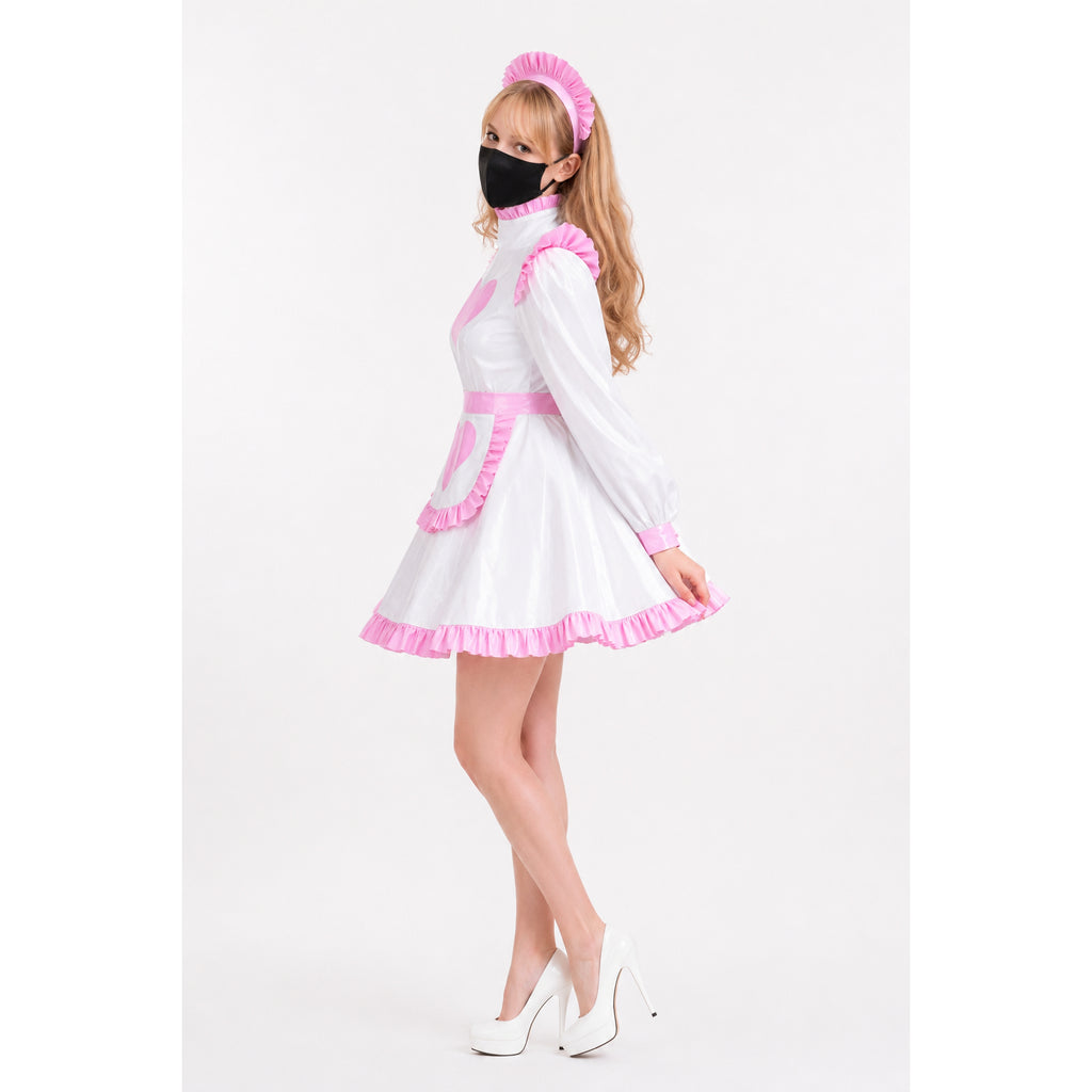 White and pink sissy maid dress with ruffles, apron, and headband, paired with white heels