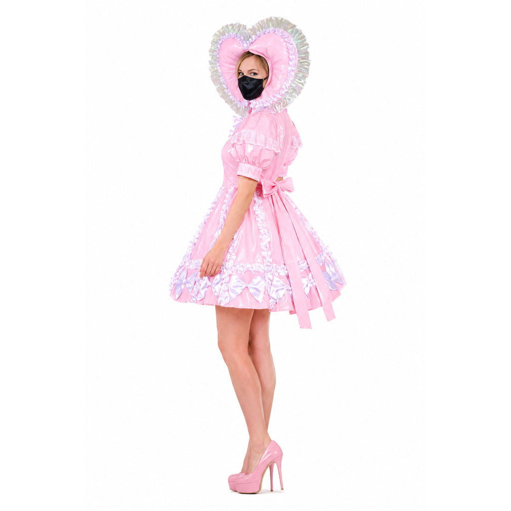 Pink sissy maid dress with heart hood, ruffles, and bows, paired with matching heels