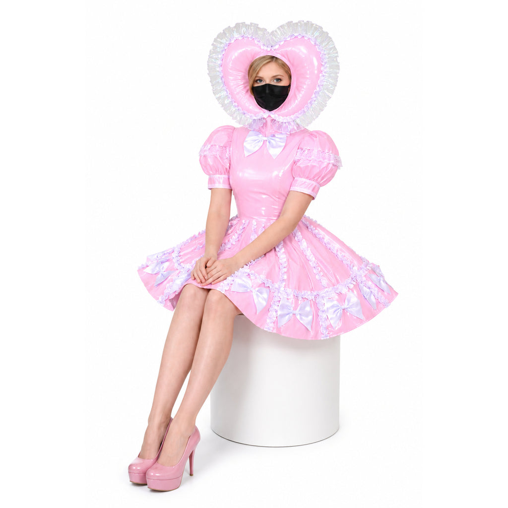 Pink sissy maid dress with heart hood, ruffles, and bows, paired with matching heels