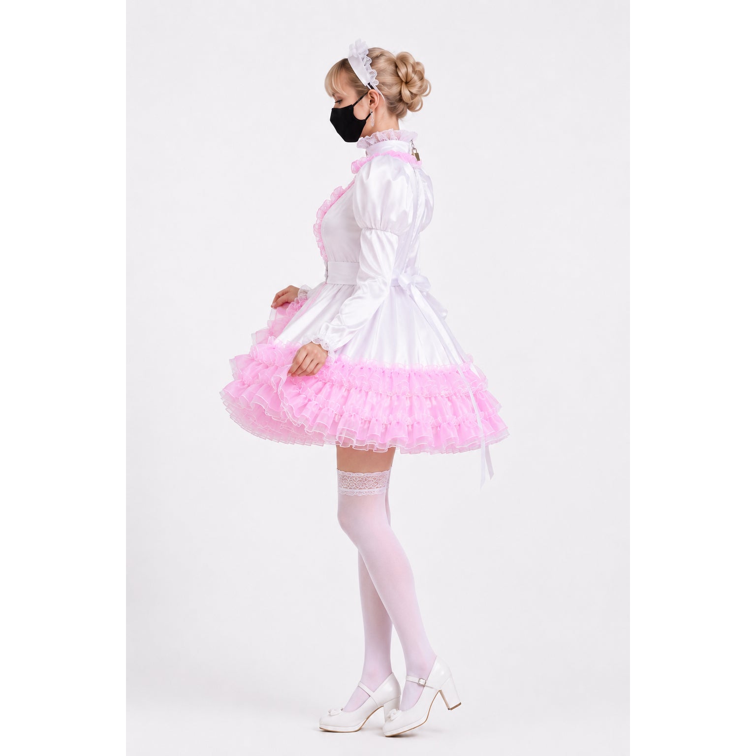 White and pink sissy maid dress with ruffles, lace trim, and matching headband, styled with white heels and stockings.