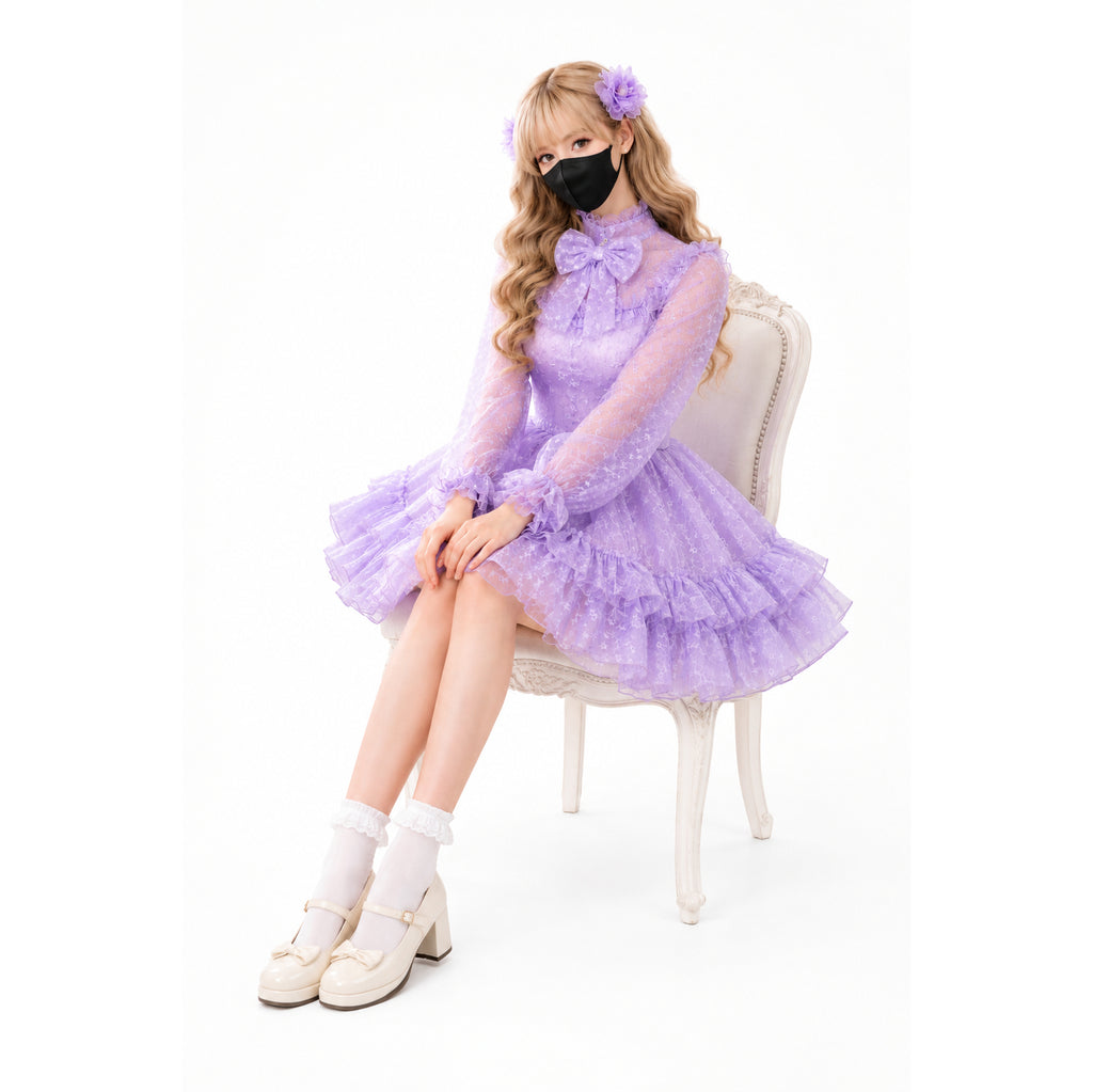 Purple sissy maid dress with ruffles, bow, and sheer sleeves, worn with white socks and heels.