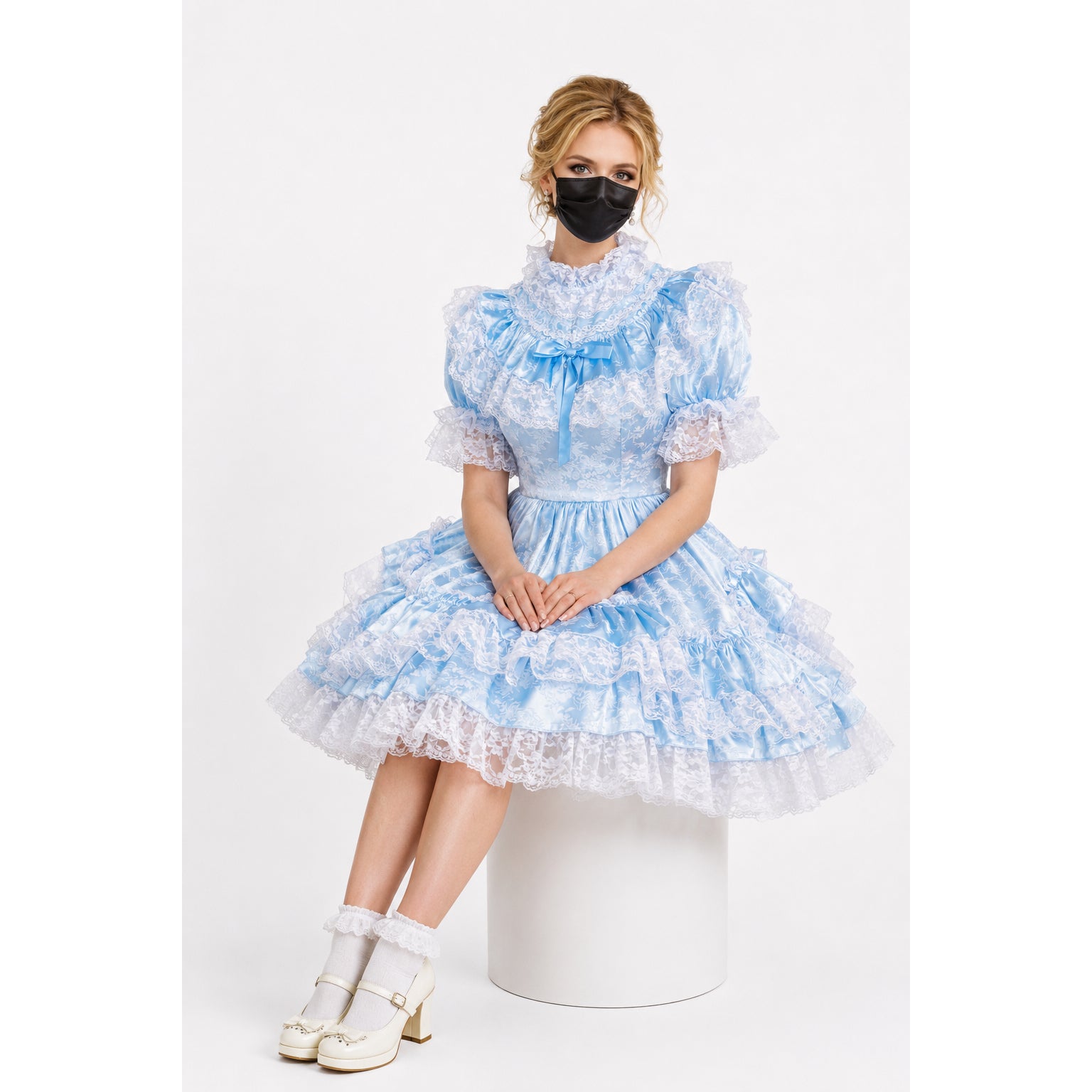 Light blue sissy maid dress with lace ruffles, puff sleeves, and bow detail, paired with white heels and socks.