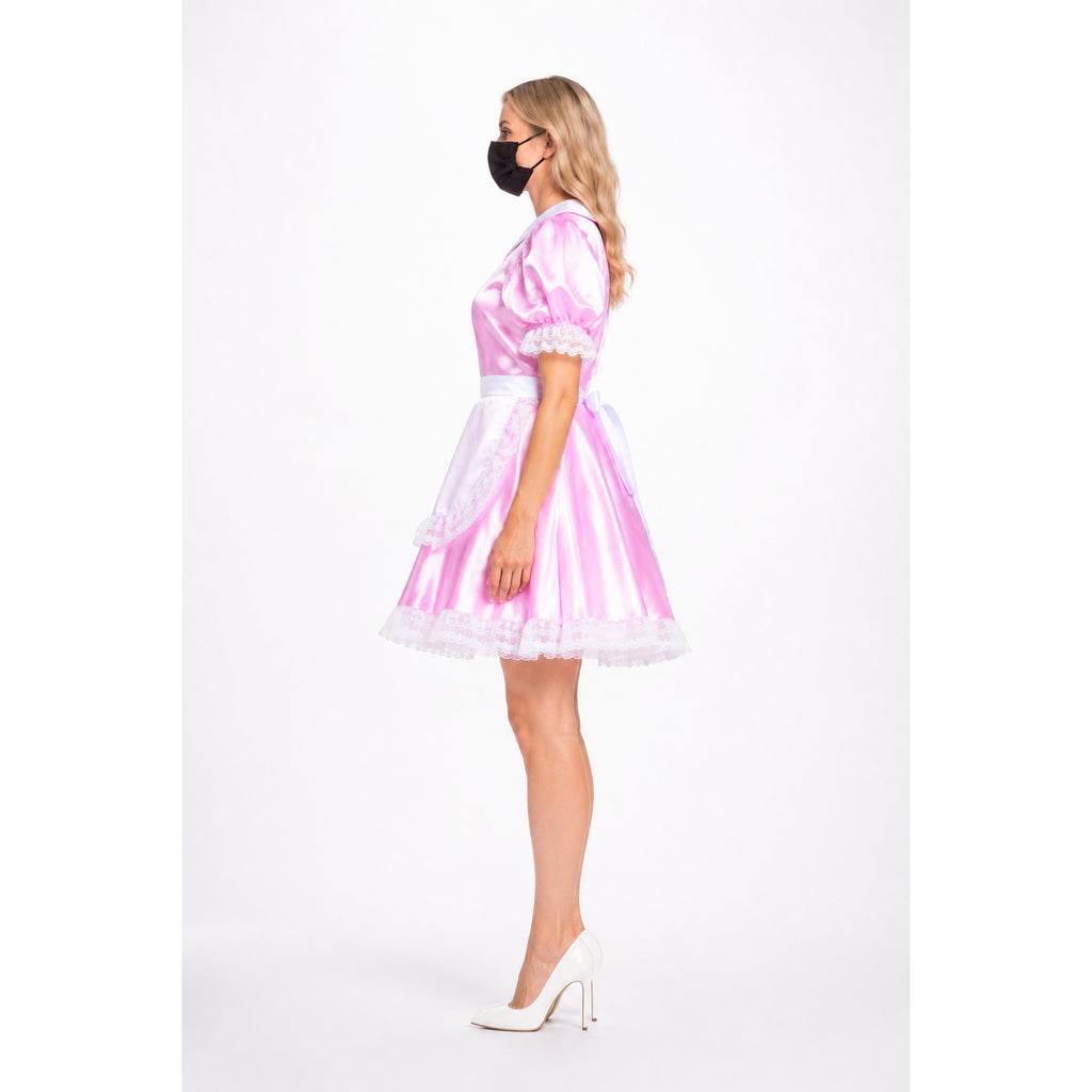 Pink satin sissy maid dress with white lace trim and bow, styled with white heels