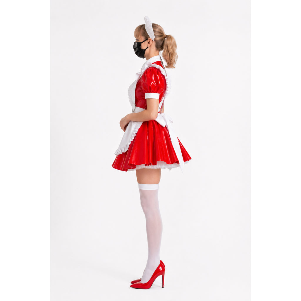 Red PVC sissy maid dress with white apron, thigh-highs, and heels, side view