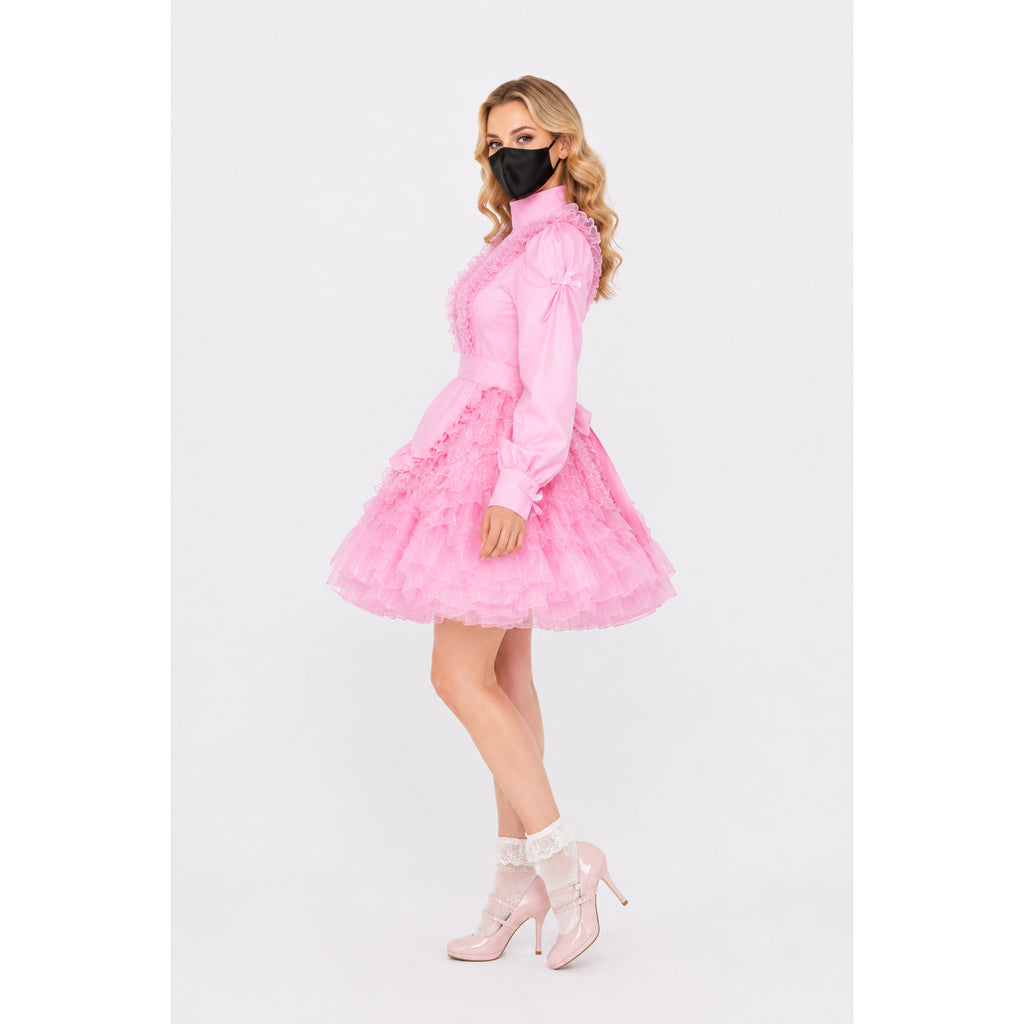 Pink sissy maid dress with ruffles, high collar, and tiered skirt, paired with lace socks and heels