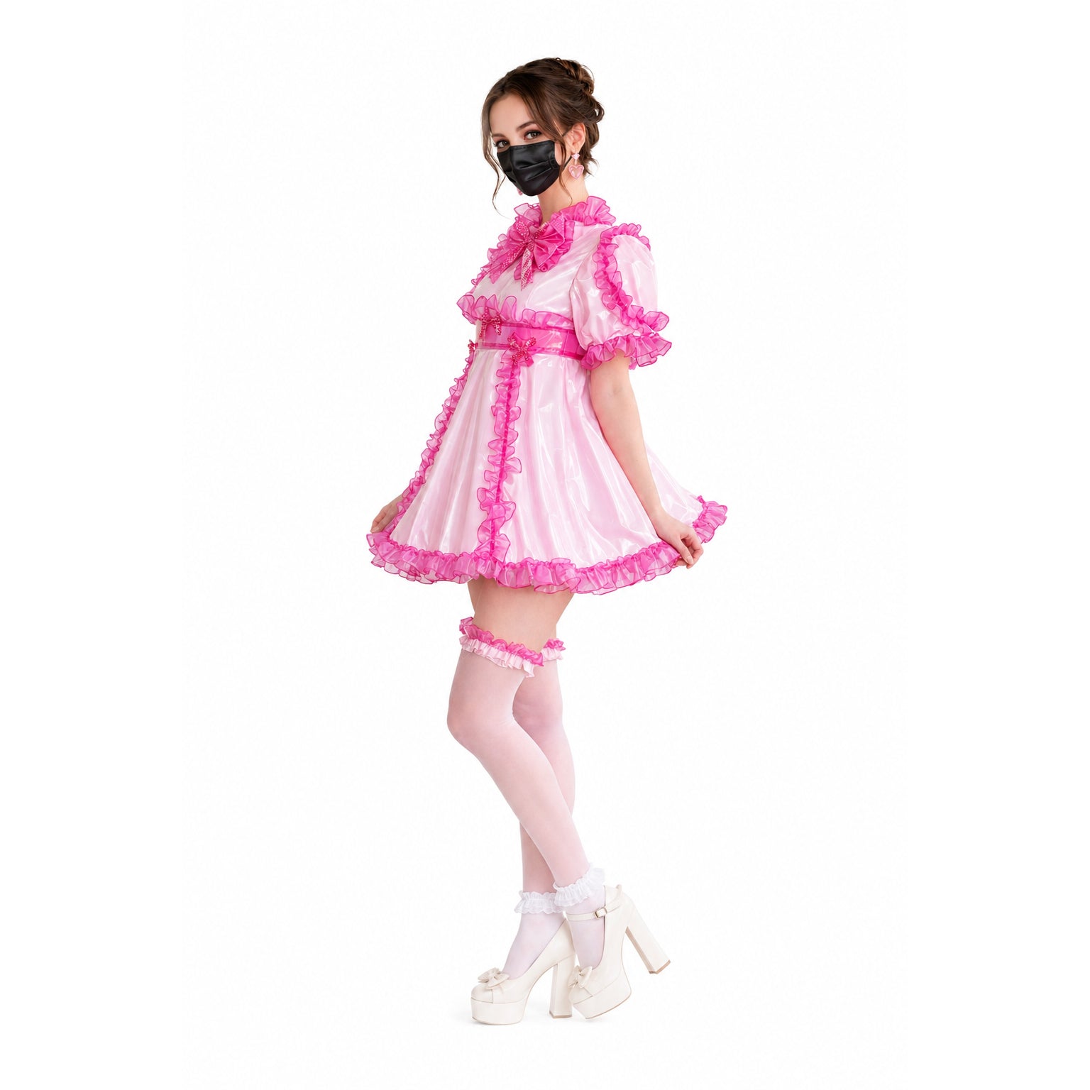 Pink sissy maid dress with ruffles, PVC material, and matching garters, styled with white platform heels.