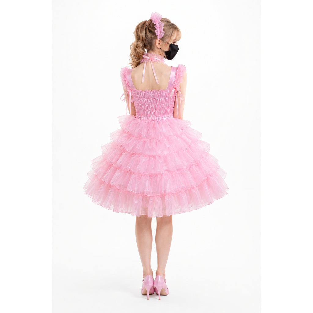 Pink sissy maid dress with ruffled tulle skirt, bow straps, and matching heels, shown from back