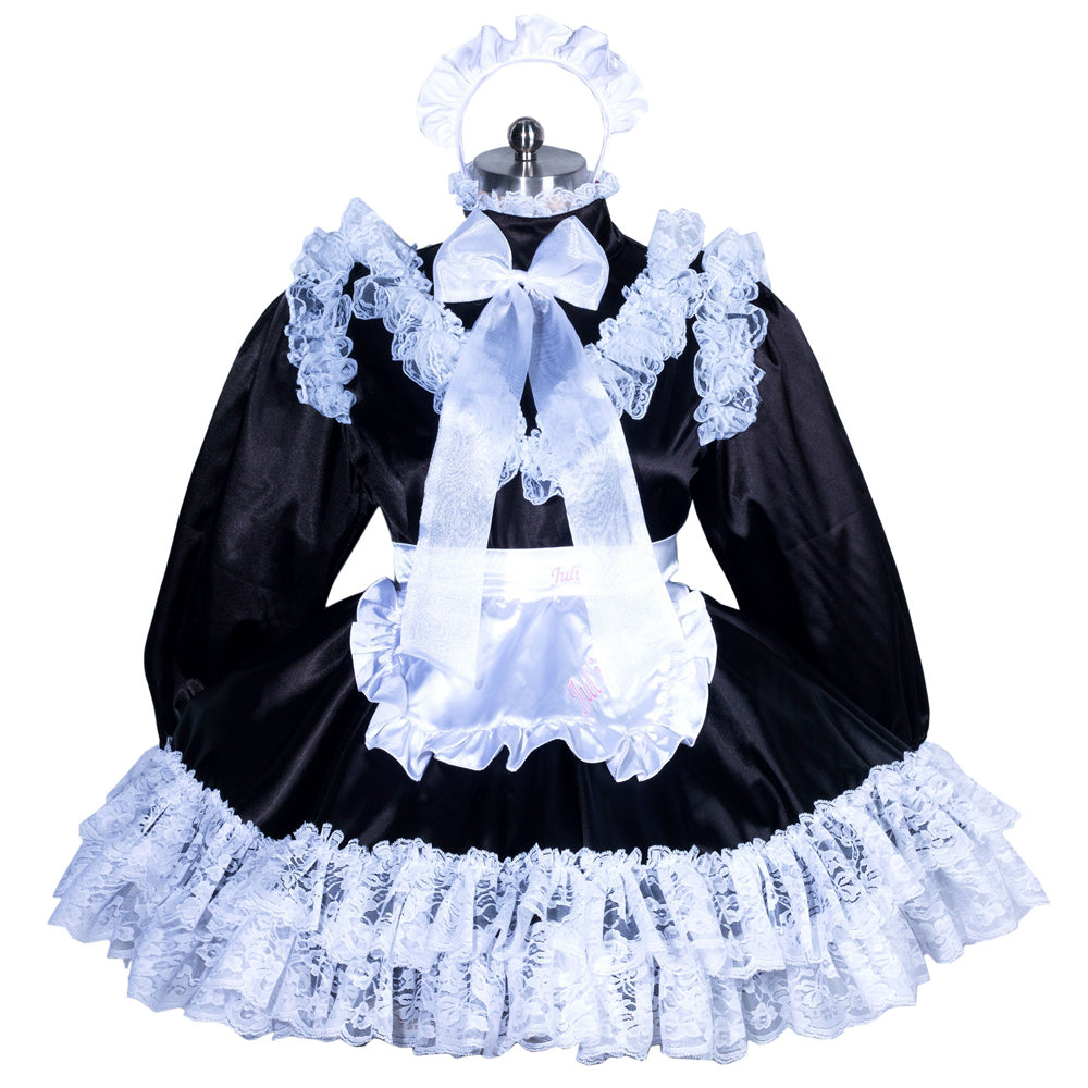 Black sissy maid dress with white lace, bow, and apron on mannequin