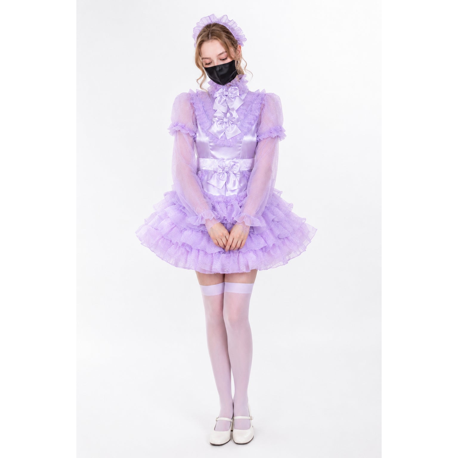 Lavender sissy maid dress with ruffles, sheer sleeves, and bow details, paired with matching stockings and heels.