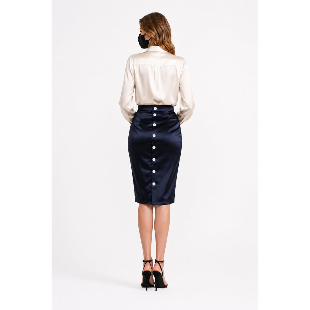 Back view of woman in satin sissy maid dress set with buttoned navy skirt and cream blouse