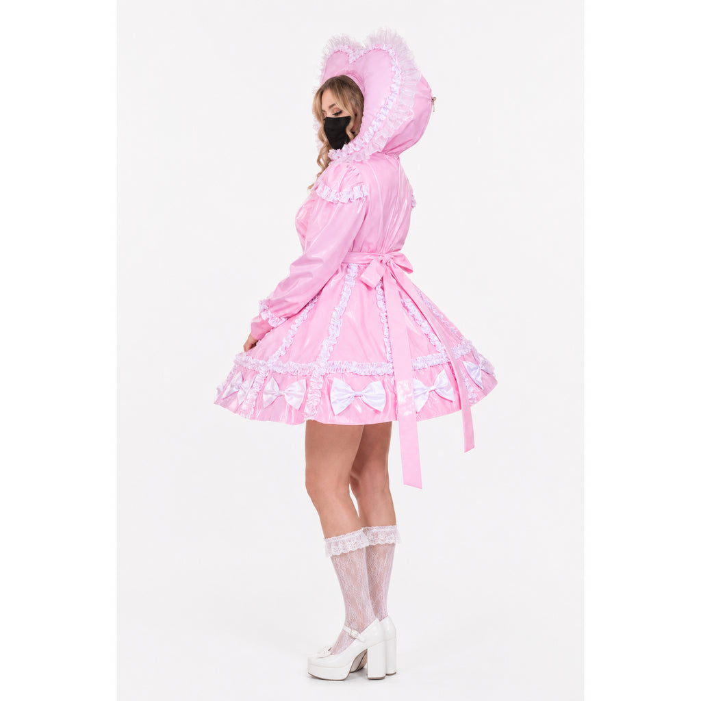 Pink sissy maid dress with heart hood, ruffles, and bows, paired with lace socks and white heels