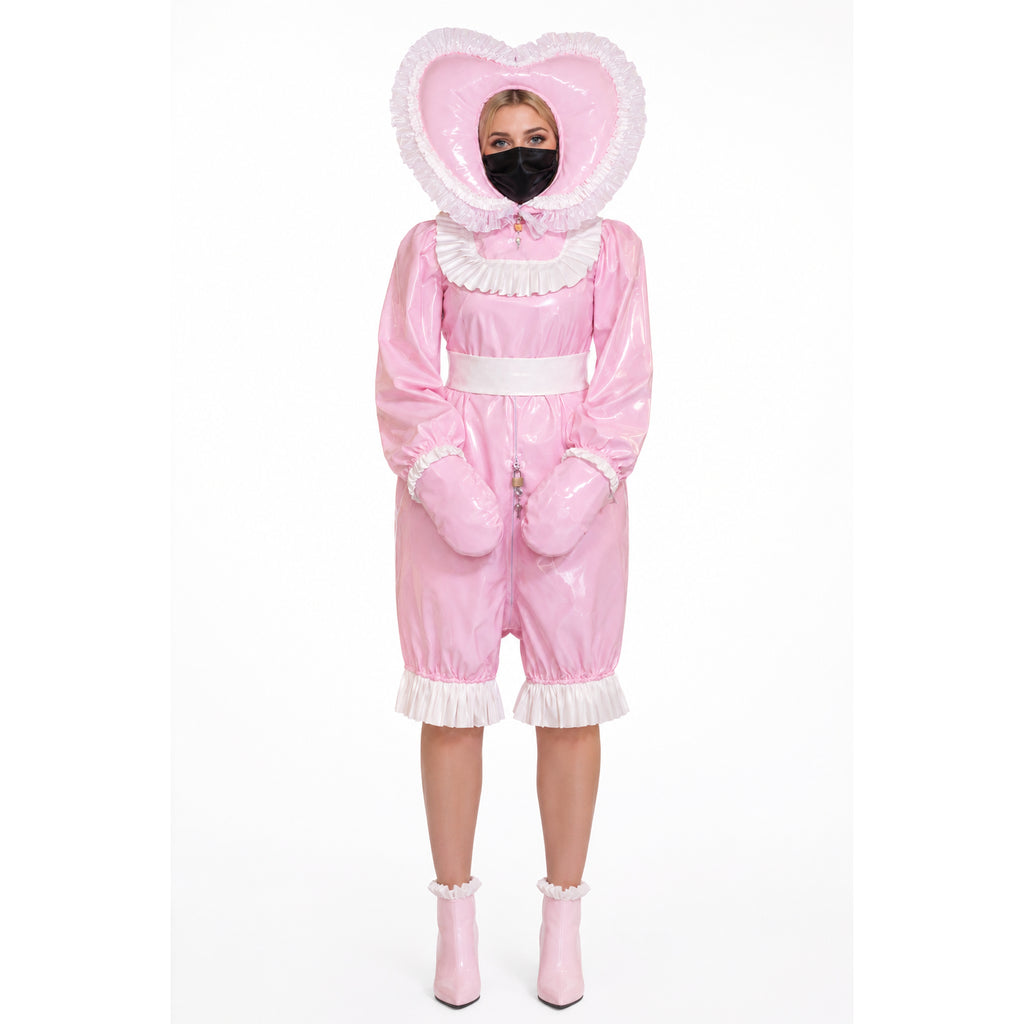 Pink PVC sissy maid dress with heart hood, ruffles, and lockable front, paired with matching boots