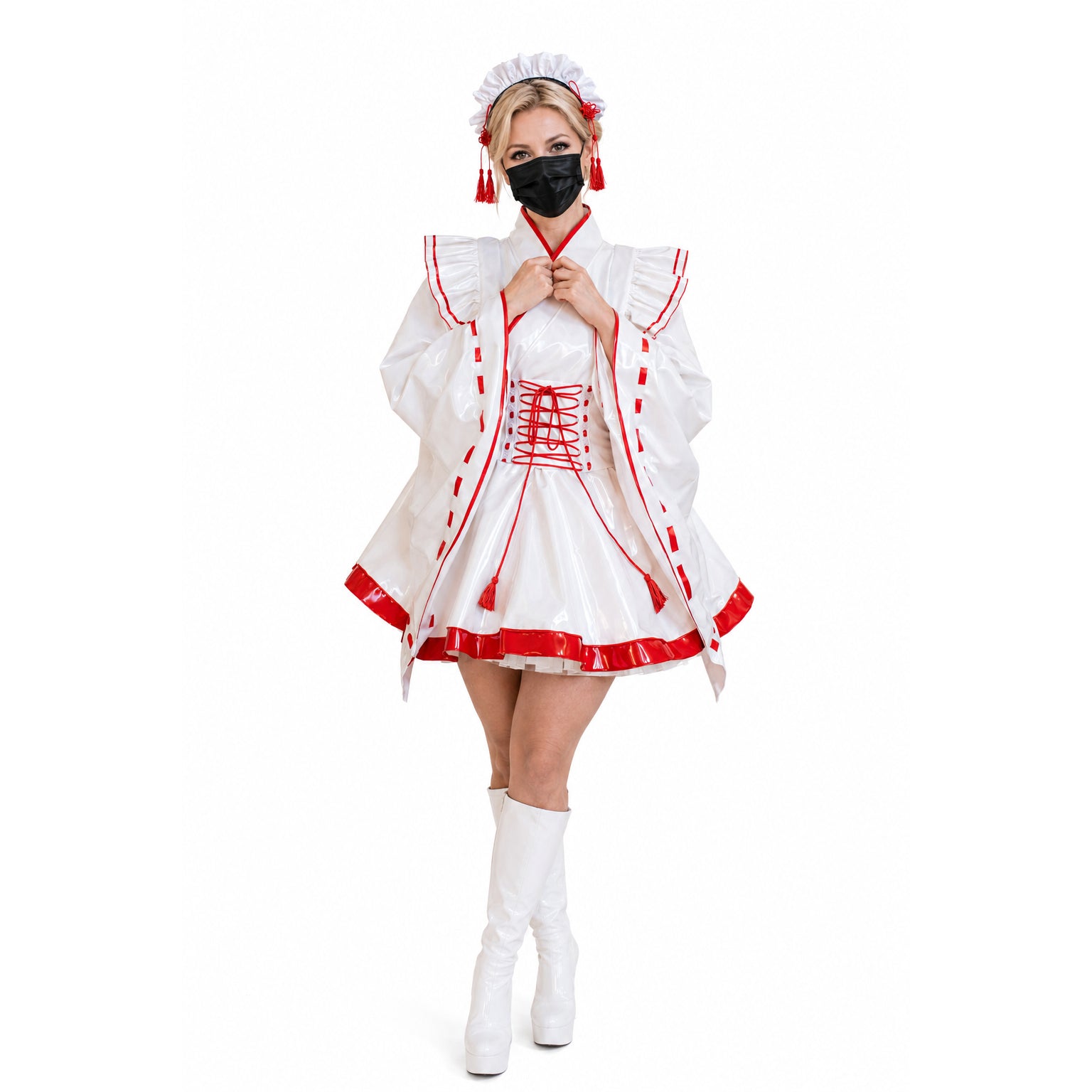 White PVC sissy maid dress with red trim, lace-up front, and matching hat, styled with white boots.