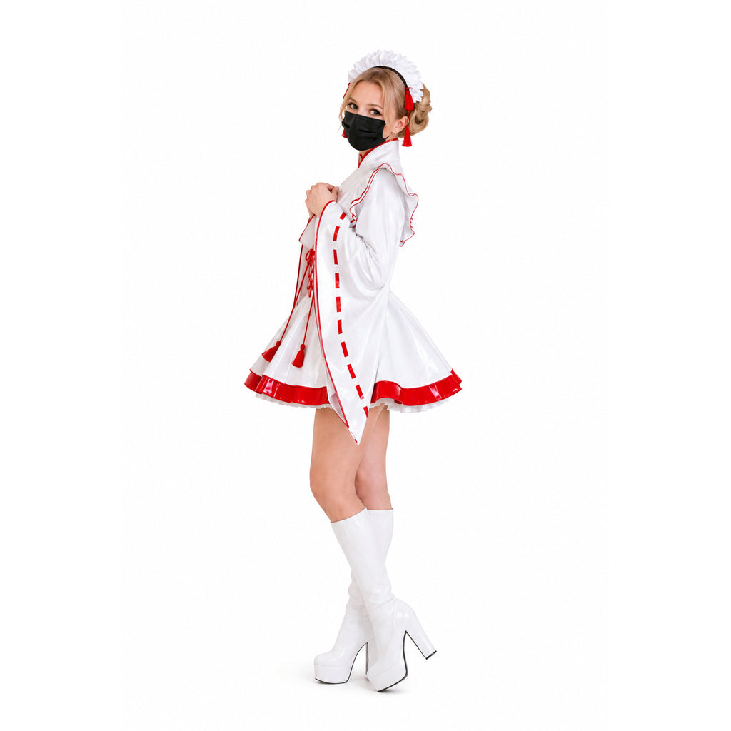 White PVC sissy maid dress with red trim, ruffles, and matching hat, paired with white platform boots.