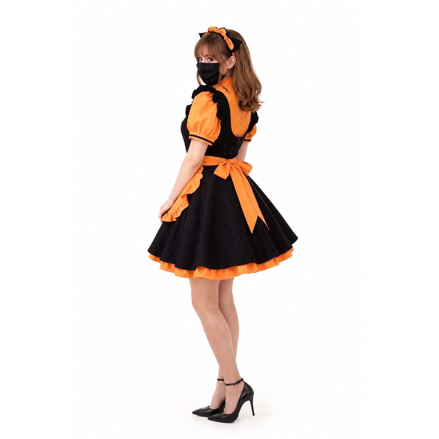 Black and orange sissy maid dress with ruffles, bow, and cat ears, paired with heels