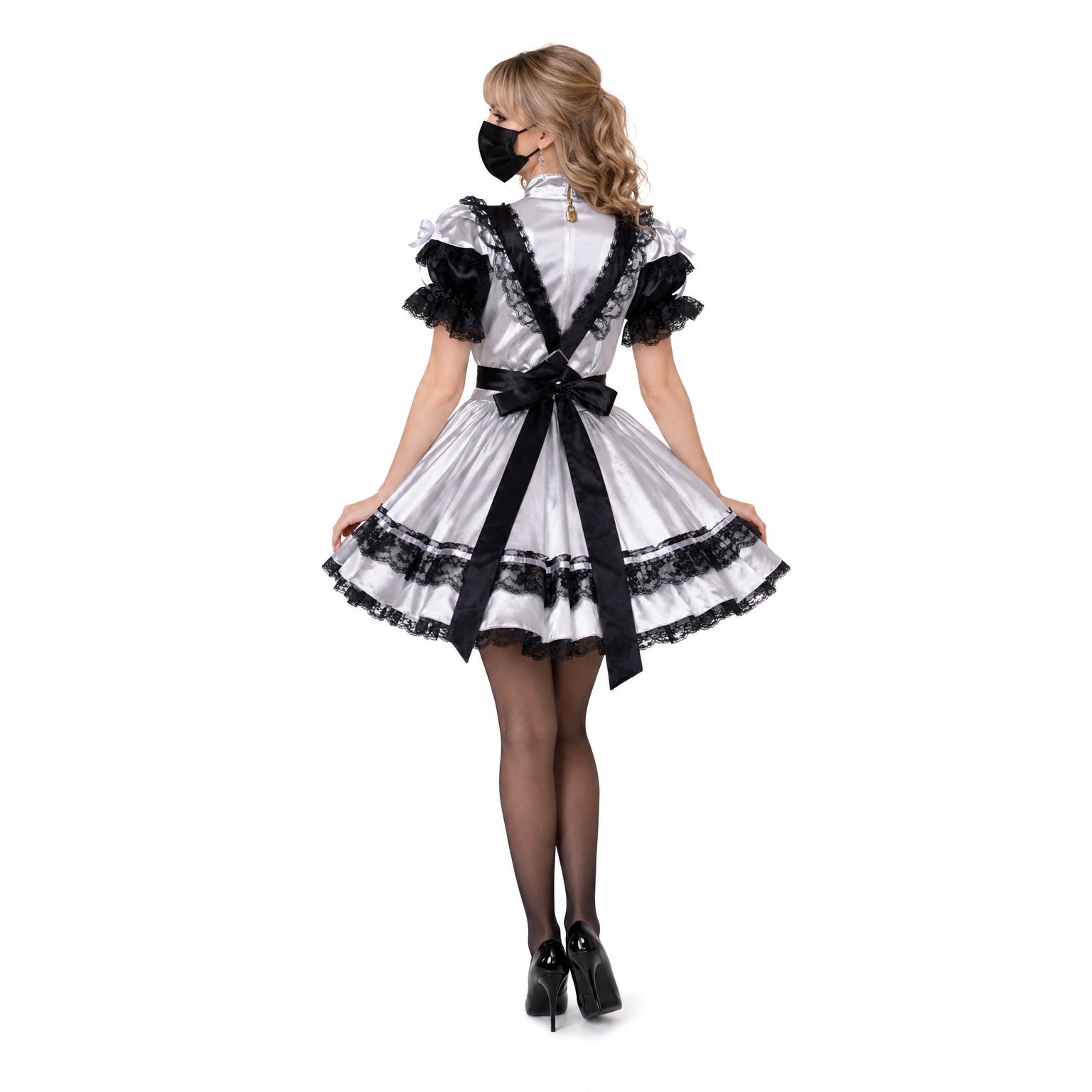 White satin sissy maid dress with black lace trim, bow, and suspenders, worn with heels and mask