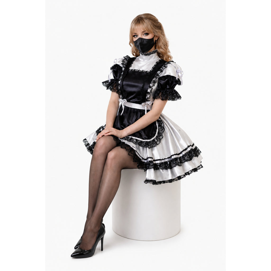 Black and white sissy maid dress with lace trim, satin finish, and ruffled sleeves, worn with heels and mask