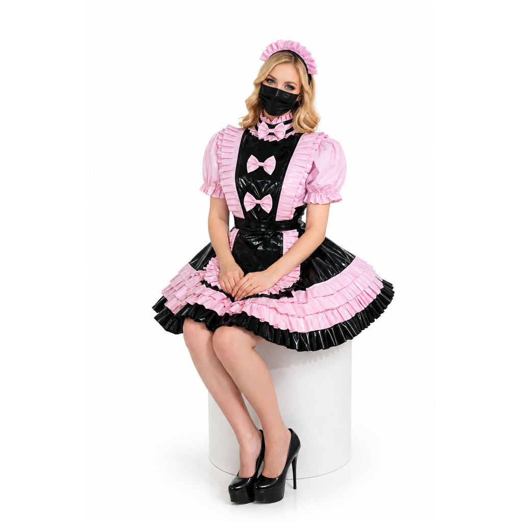 Pink and black sissy maid dress with ruffles, bows, and PVC apron, styled with matching headband and heels