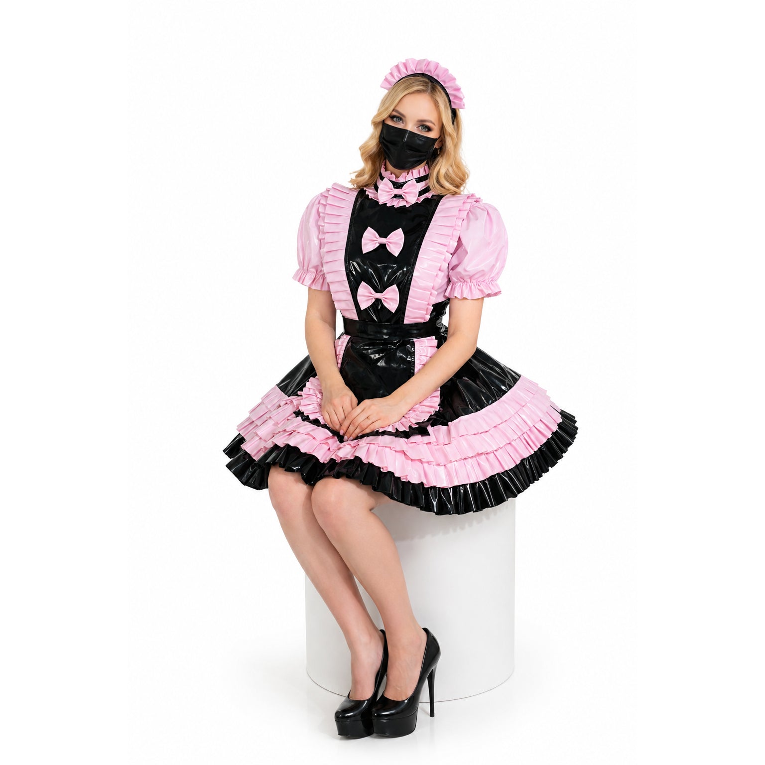 Pink and black sissy maid dress with ruffles, bows, and PVC apron, styled with matching headband and heels