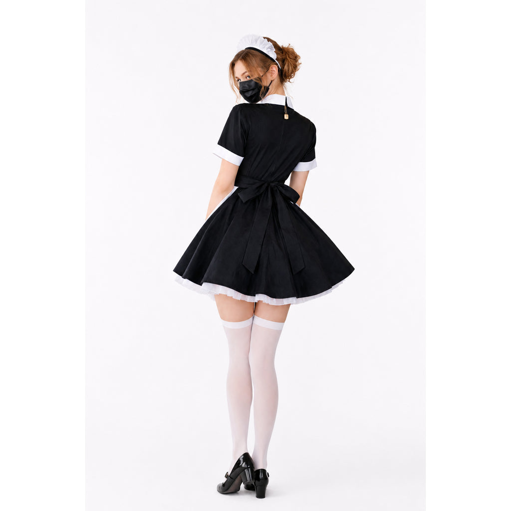 Black sissy maid dress with white trim, bow, and matching headpiece, worn with white stockings and heels