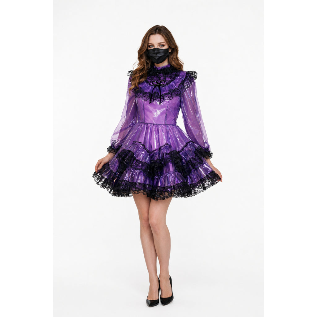 Purple PVC sissy maid dress with black lace trim, ruffled skirt, and long sleeves, paired with black heels.