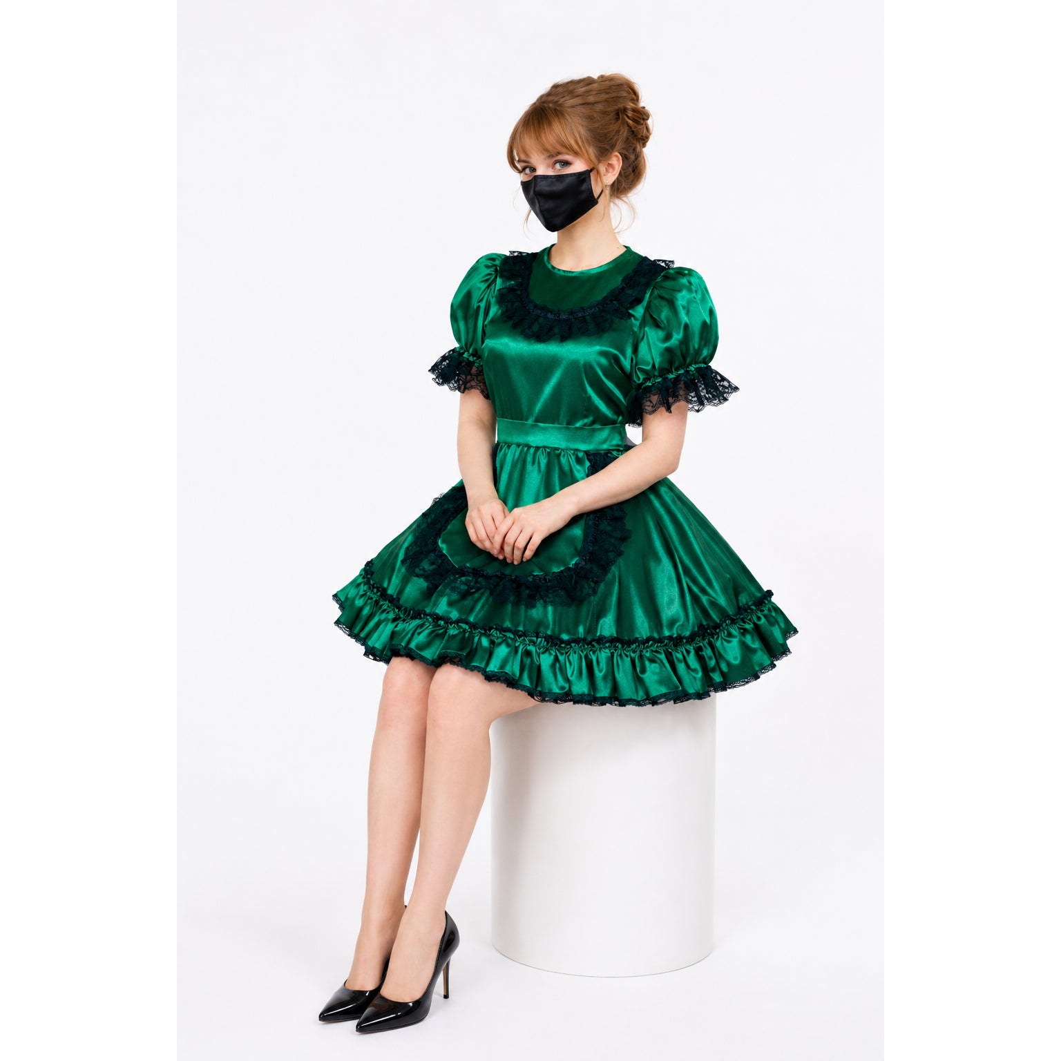 Emerald green sissy maid dress with black lace trim, puffed sleeves, and ruffled skirt, paired with black heels.