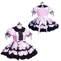 Pink and black sissy maid dress with ruffles, lace, and bow details on mannequin