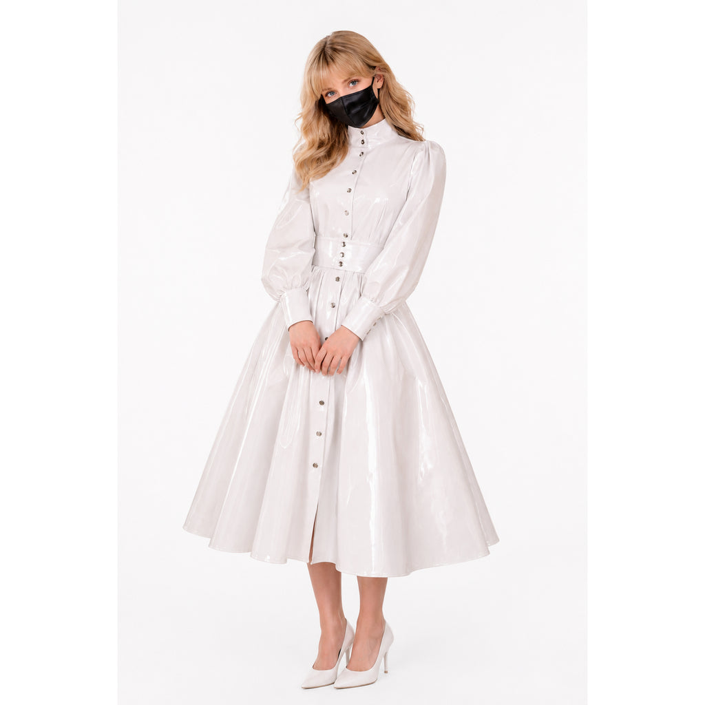 White PVC sissy maid dress with button front, puffed sleeves, and flared skirt, paired with matching heels