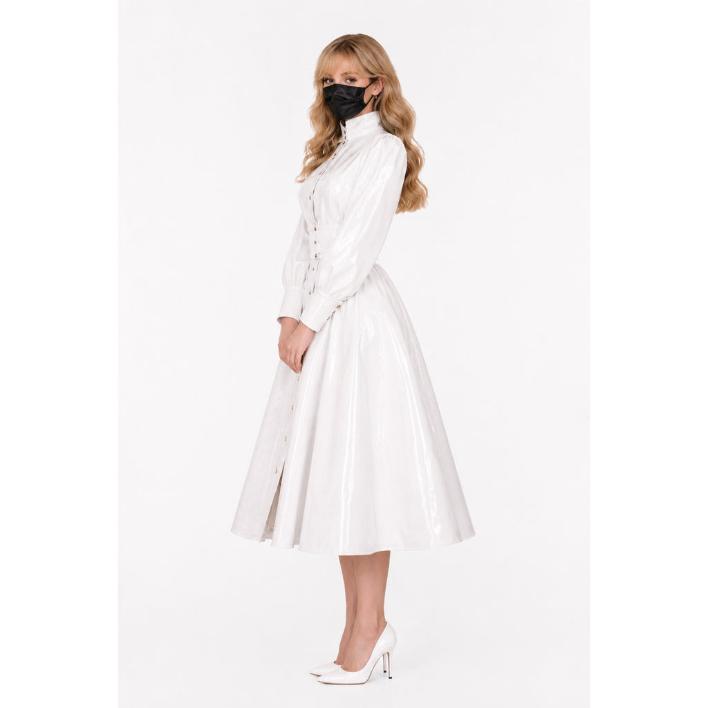 White PVC sissy maid dress with button front, flared skirt, and high heels