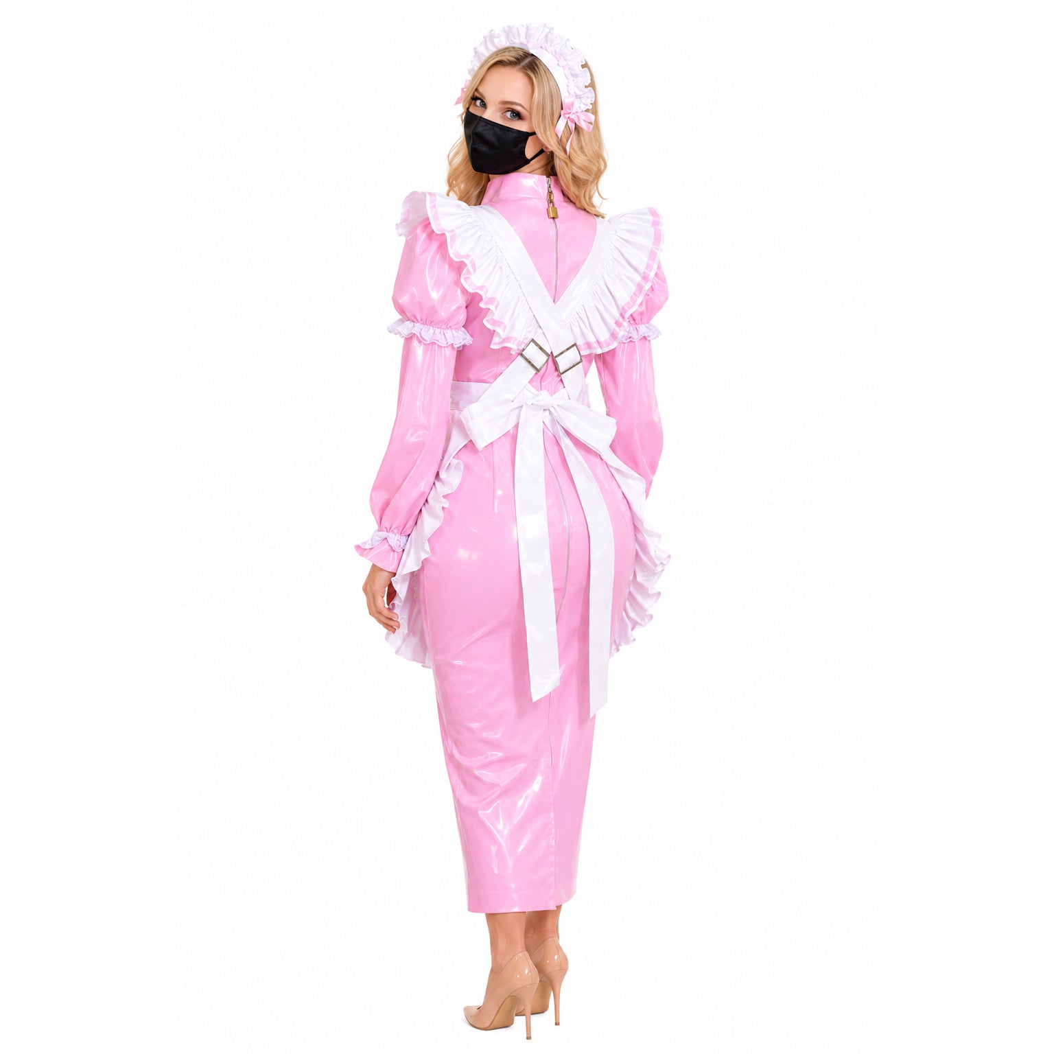 Pink PVC sissy maid dress with white ruffles, bow, and headpiece, worn with heels